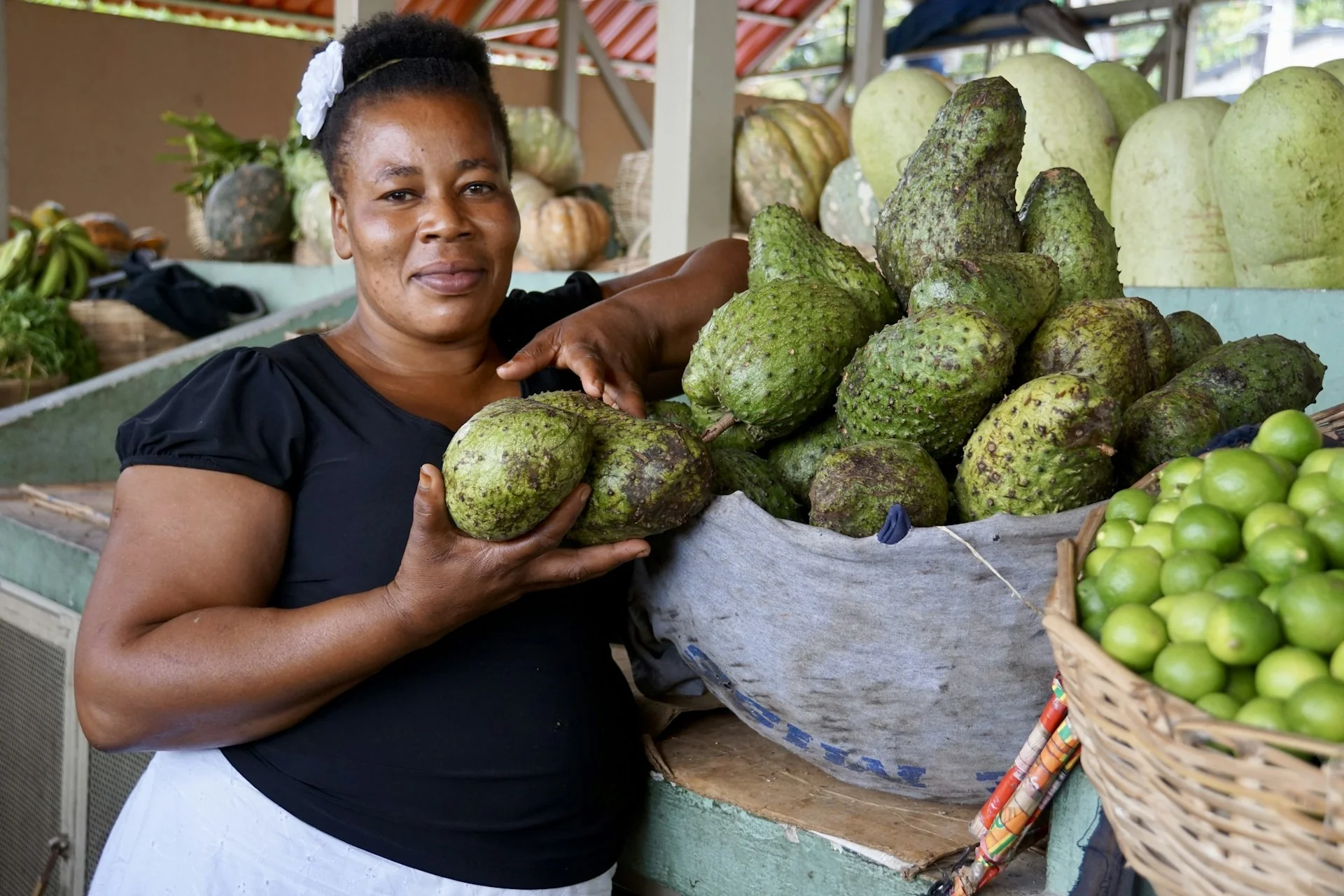 A market trader with fresh soursop and limes in Port-au-Prince, Haiti